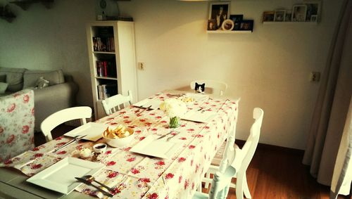 Close-up of chairs and table at home