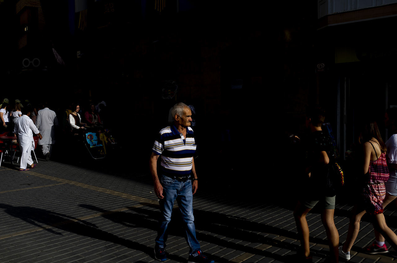 group of people, real people, lifestyles, full length, women, people, men, adult, casual clothing, architecture, walking, night, leisure activity, group, city, built structure, togetherness, crowd, street