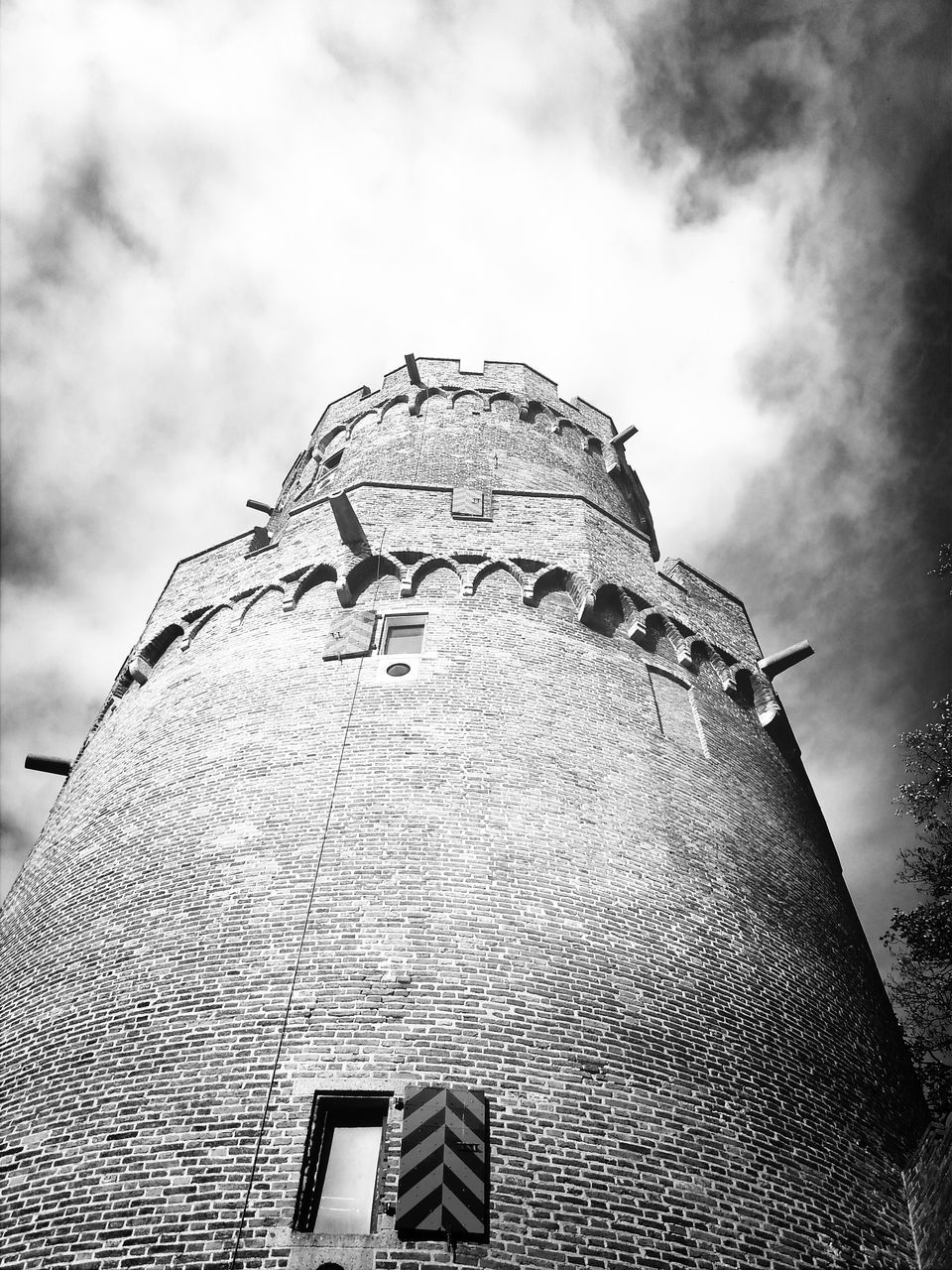 low angle view, sky, built structure, architecture, building exterior, cloud - sky, cloudy, cloud, history, outdoors, day, no people, old, pattern, travel destinations, famous place, art and craft, building, tower, overcast