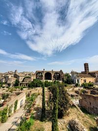 View of old buildings against cloudy sky