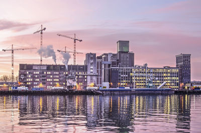 Rotterdam grain silo and construction cranes at sunrise