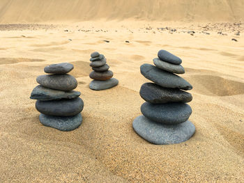 Stack of stones on sand at beach
