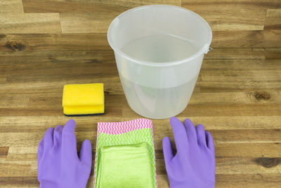 High angle view of gloves and bucket on table