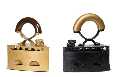 Close-up of padlocks against white wall