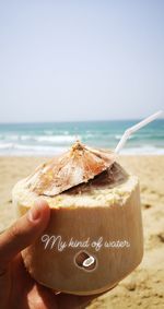 Person holding ice cream on beach