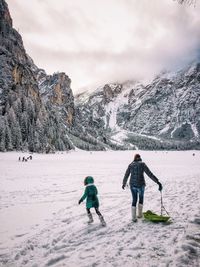 People standing on snow covered landscape