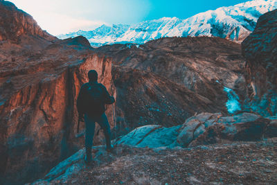 Rear view of man standing on mountain