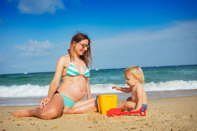 Portrait of young woman sitting on beach