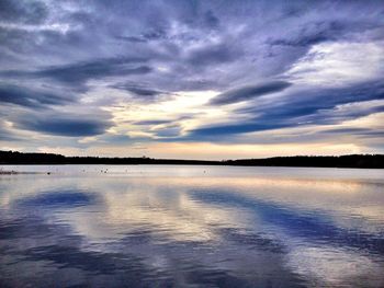 Scenic view of lake against sky at sunset