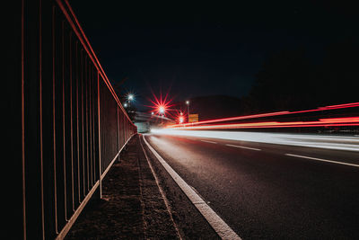 Light trails on road in city at night