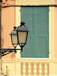 Lamps against closed window of building