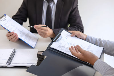 Midsection of man using laptop on table