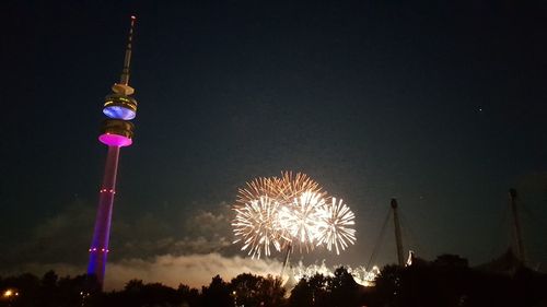 Low angle view of firework display at night