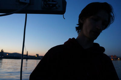 Close-up portrait of young man against sky during sunset