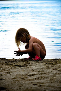 Side view of girl playing at beach