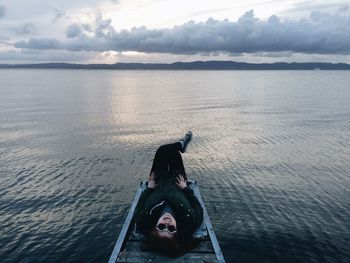 High angle view of woman lying on boat in river