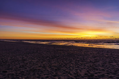 Scenic view of beach against sky during sunset