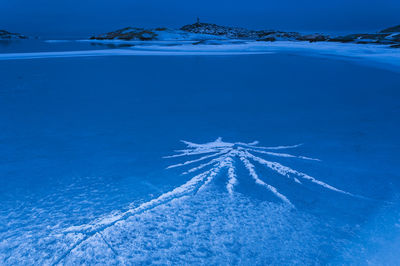 Ice patterns on frozen sea at dusk