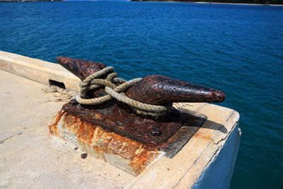 Close-up of rusty chain on sea