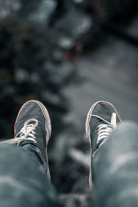 Low section of person wearing shoes standing outdoors