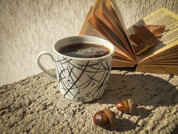 Close-up of coffee by book