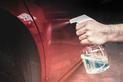 Close-up of hand holding glass of water