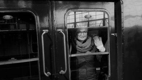 Portrait of woman seen through train door