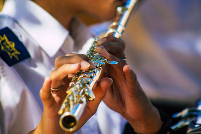 Midsection of man playing guitar