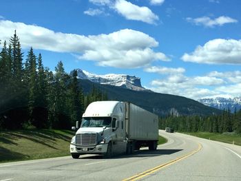 Cars on road against sky