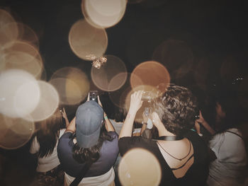 Rear view of people enjoying at music concert