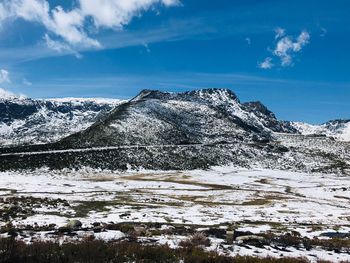 Snow covered mountain against blue sky