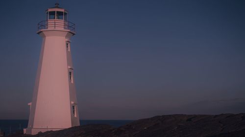 Lighthouse against sky at night