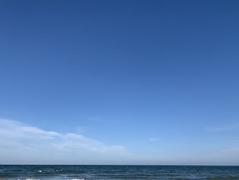 Scenic view of sea against blue sky