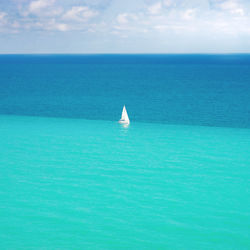 Sailboat sailing in sea against sky