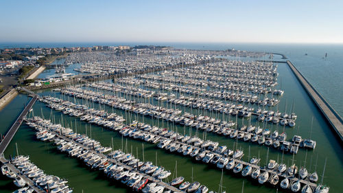 High angle view of cityscape by sea against sky