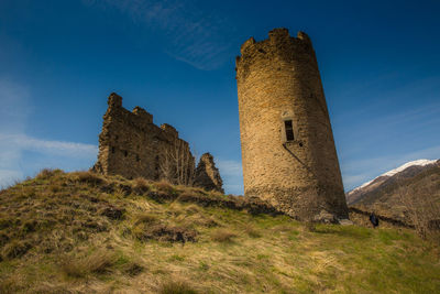 Low angle view of castle against blue sky