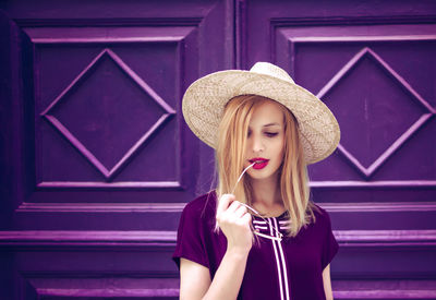 Close-up portrait of young woman wearing hat