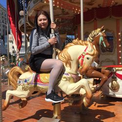 People sitting on carousel at amusement park