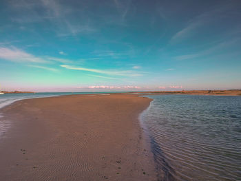 Scenic view of beach against blue sky