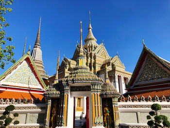 Low angle view of temple building against blue sky