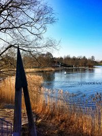 Calm lake against clear sky