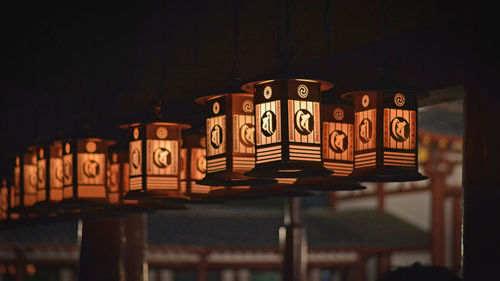 Close-up of illuminated text on table at night