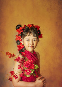 Portrait of woman standing against red wall