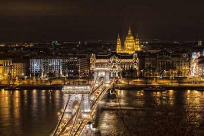 Illuminated szechenyi chain bridge over danube river at night