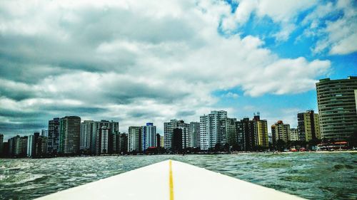 City skyline against cloudy sky