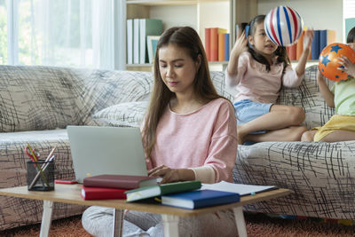 Young woman using laptop at home