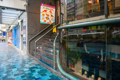 Street by swimming pool against buildings in city