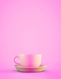 Close-up of coffee cup against pink background