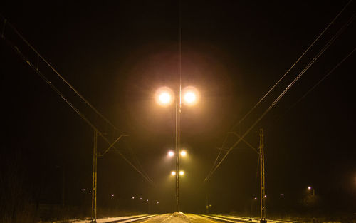 Illuminated lights against sky at night