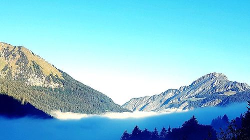 Scenic view of snowcapped mountains against clear sky